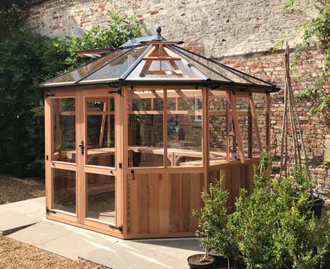large round Cedar Greenhouse 12ft x 10ft wooden greenhouse for garden focal point